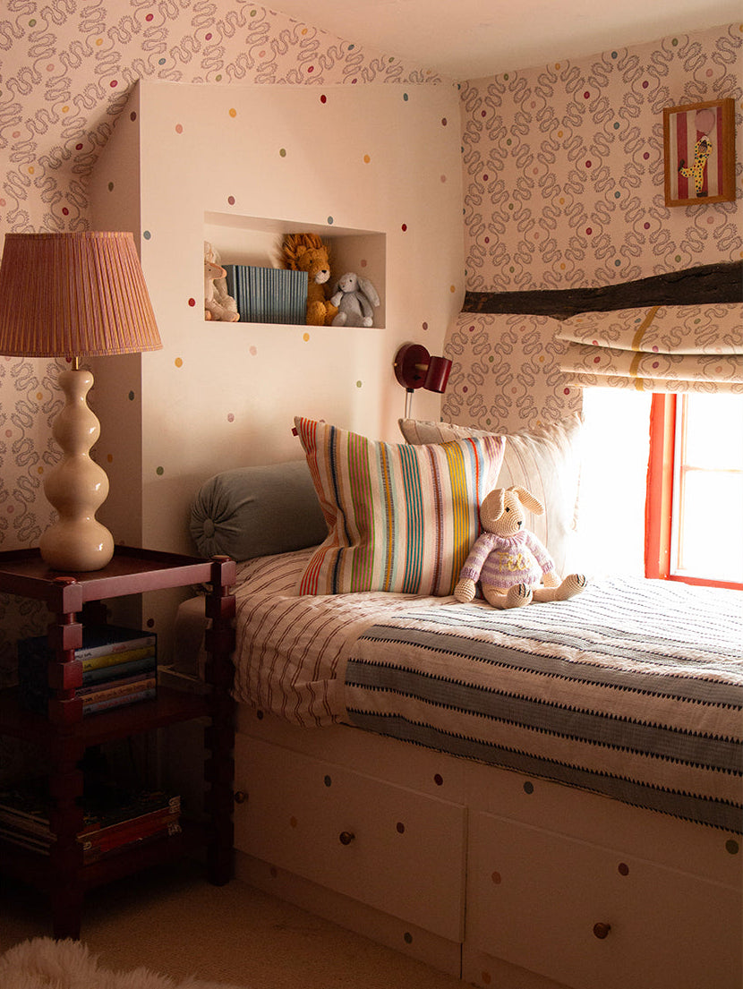 Children's bedroom with a bed, nightstand, and teddy bears.